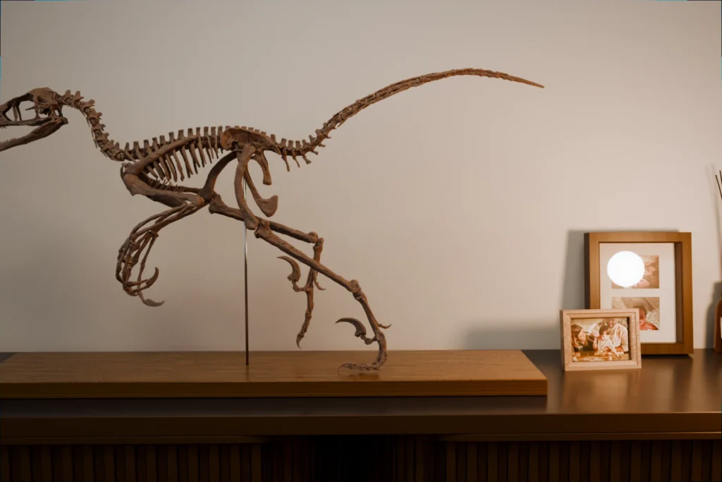 Bambiraptor skeleton beside photo frames and a reed diffuser, showing its size